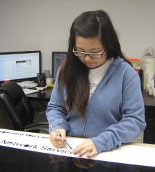 Allison weeding at Auto Trim as a Graphic Designer